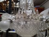 a glass chandelier hanging from a ceiling in a store