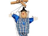a small doll with a wooden stick attached to it ' s head