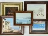many pictures hanging on the wall of this room
