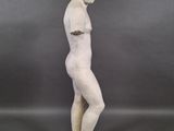 a white statue of a man standing on top of a wooden base
