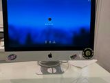 a computer monitor sitting on a white desk with a blue screen