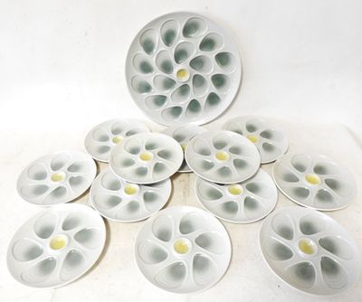 many white plates with yellow flowers on them on a table
