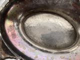 a silver bowl with a hole in the middle of it