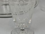a glass cup and saucer on the table