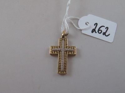 a gold cross hanging from a string with a price tag