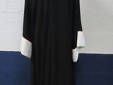 a black and white robe on a mannequin stand