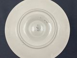 a white plate on a black table with a blue background