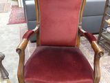 red velvet upholstered chair in a store with other furniture