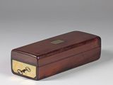 an image of a wooden box with a brass plate on the lid