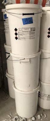 several white buckets stacked on top of each other in a garage