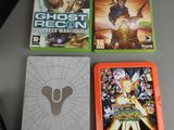 three video games on the table next to a mouse