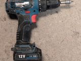 a drill that is laying on the ground next to a piece of wood