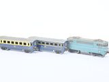 two toy trains on a white surface one is blue and the other is yellow