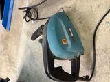 a blue and black corded blower sitting on the floor