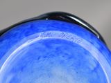 a blue glass vase with writing on it