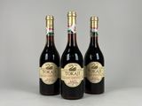 three bottles of wine sitting next to each other on a table