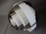 an overhead view of a bowl with four pieces of paper in it