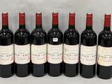 six bouteilles de vin rouge alignées sur une table