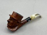 a pipe with a man ' s face on it