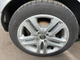 a close up of a tire on a car in a parking lot