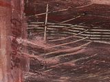a painting of a cross on the side of a building