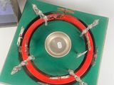 a picture of a red and green ring on a green plate