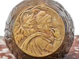 an antique bronze figurine of a woman and child on a marble surface