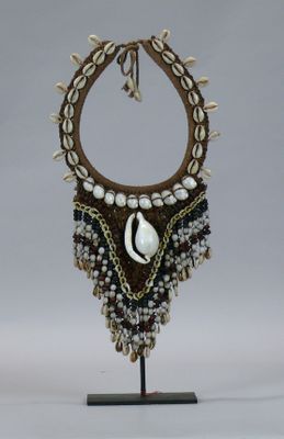 a picture of a necklace with a cowrie shell on it