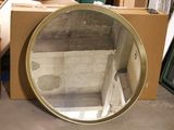 a mirror that is sitting on the floor in front of a box