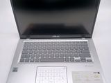 a silver laptop with a keyboard and mouse on it