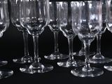 many empty wine glasses lined up on a black table