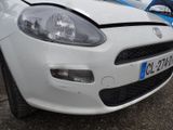 a white car parked in a parking lot with other cars in the background