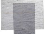several old papers are stacked on top of each other on a white surface