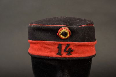 un chapeau noir orné d'un ruban rouge