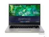 the laptop is open on a white surface with a green background