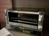 a toaster oven sitting on a counter in a kitchen