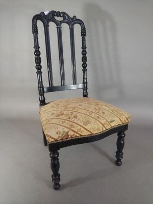 a black chair with a patterned seat and back