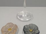 three small glass dishes sitting on a white table
