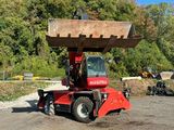 a red tractor with a large bucket on the back of it