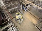 a machine that is working on a conveyor belt in a factory