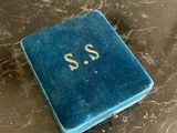 a small blue book sitting on a marble table