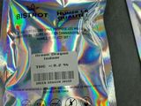 a close up of a bag of silver foil next to a pair of scissors