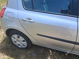 a small silver car that is parked in the grass