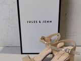 an image of a pair of nude colored sandals with a box in the background