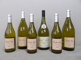 six bottles of wine are lined up in a row on a table
