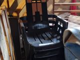 a plastic chair that is sitting in the attic of a house
