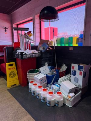 a large amount of cleaning supplies on the floor