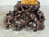 a statue of an octopus holding a piece of fruit