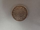 a close up of a coin on a table with a white background
