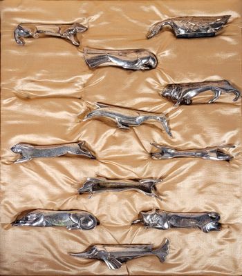 six pairs of scissors in a box on a table